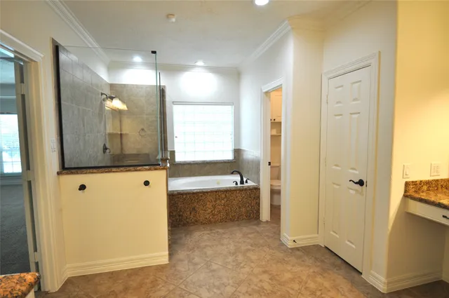 a bathroom with a glass shower door and a sink