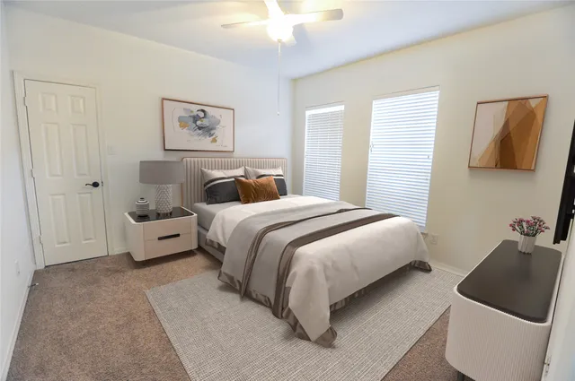 a bedroom with a bed and a couch