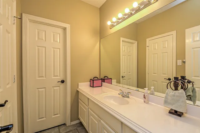 a bathroom with a double vanity sink and a mirror