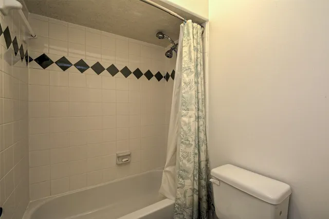a bathroom with a shower curtain