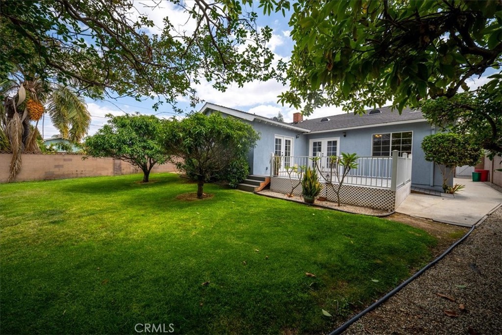 6481 Dos Rios Road Downey, CA 90240 - Photo 13 of 27 a view of a house with a backyard and a tree