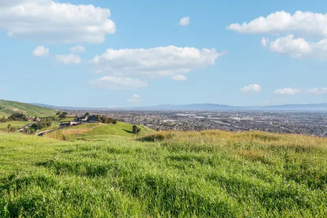 a view of a big yard with lots of green space and mountain view