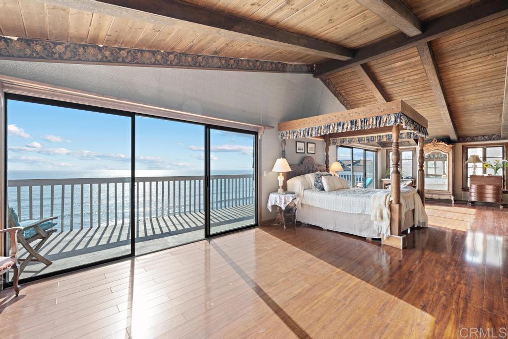 1048 Neptune Avenue Encinitas, CA 92024 - Photo 11 of 54 a bedroom with furniture and a large window