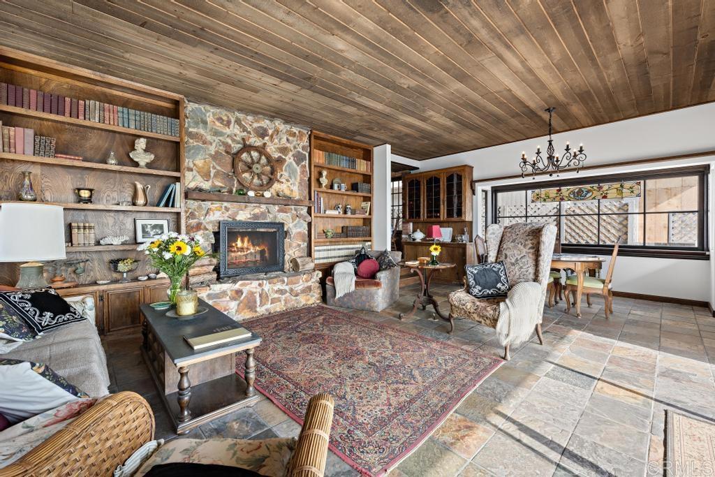 1048 Neptune Avenue Encinitas, CA 92024 - Photo 23 of 54 a living room with furniture a rug and a chandelier