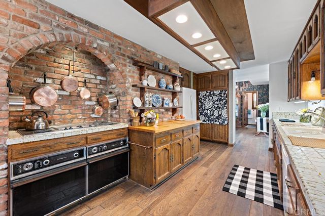 a dining room with wooden floor table and chairs