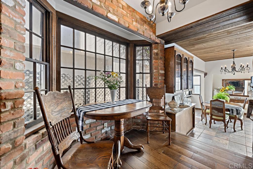 1048 Neptune Avenue Encinitas, CA 92024 - Photo 30 of 54 a dining room with wooden floor table and chairs