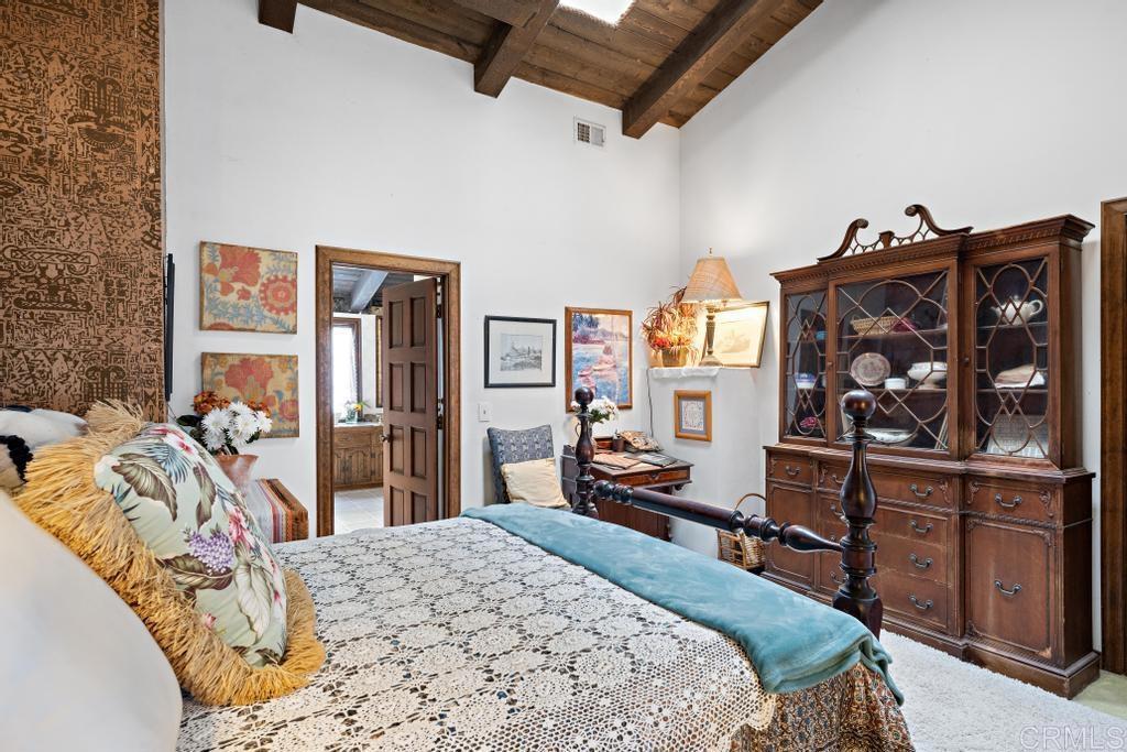 1048 Neptune Avenue Encinitas, CA 92024 - Photo 39 of 54 a bedroom with a bed dresser and a large mirror