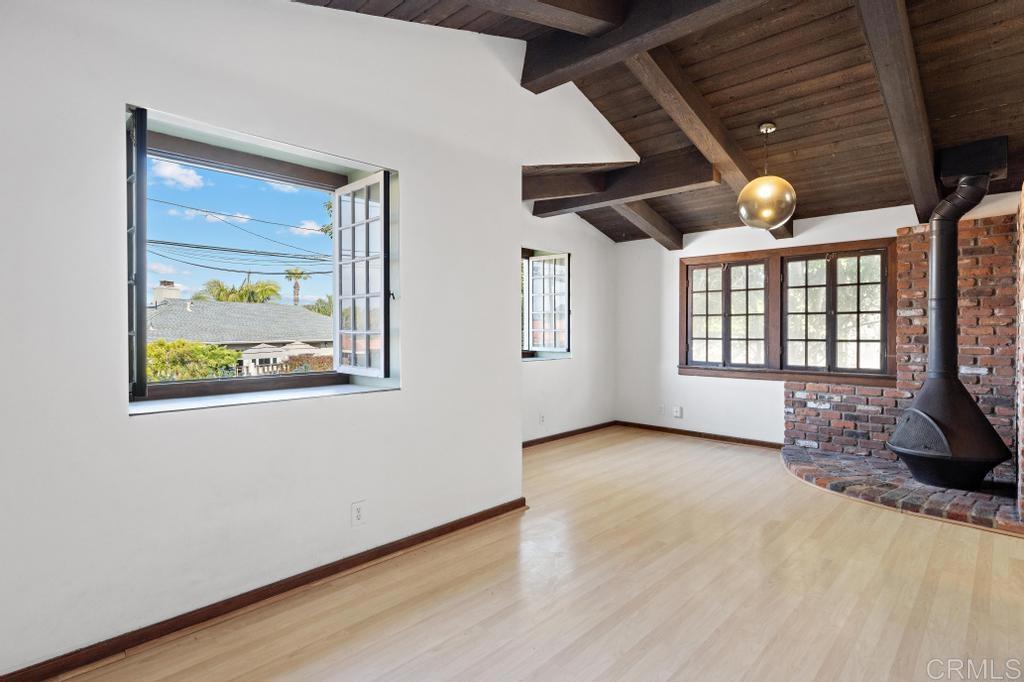 1048 Neptune Avenue Encinitas, CA 92024 - Photo 41 of 54 a view of an empty room with window and wooden floor