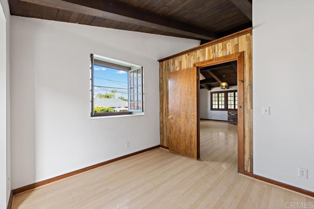 1048 Neptune Avenue Encinitas, CA 92024 - Photo 49 of 54 a view of an empty room with wooden floor and a window