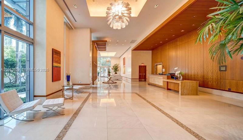 1060 Brickell Avenue, Unit 2013 Miami, FL 33131 - Photo 6 of 9 a living room with furniture and a chandelier