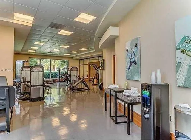 a living room with a flat screen tv and windows