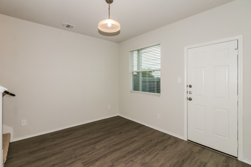 21626 Mamba Way Houston, TX 77073 - Photo 3 of 12 a view of an empty room with wooden floor and a window
