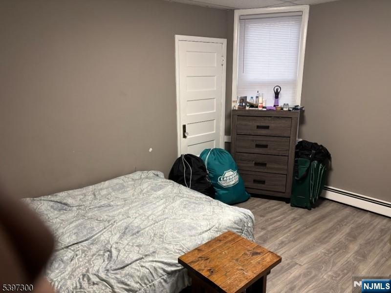 100 Harrison Place Irvington, NJ 07111 - Photo 14 of 17 a bedroom with a bed and a dresser