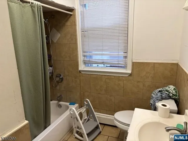 a bathroom with a sink mirror and toilet