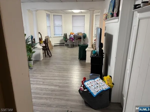 a living room with furniture and a refrigerator