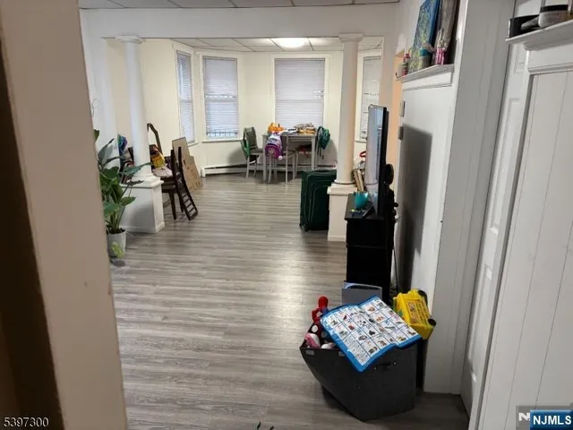 a living room with furniture and a refrigerator