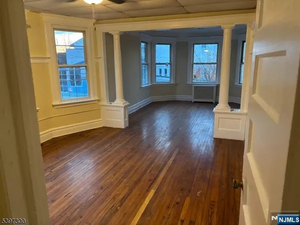 a view of an entryway with wooden floor