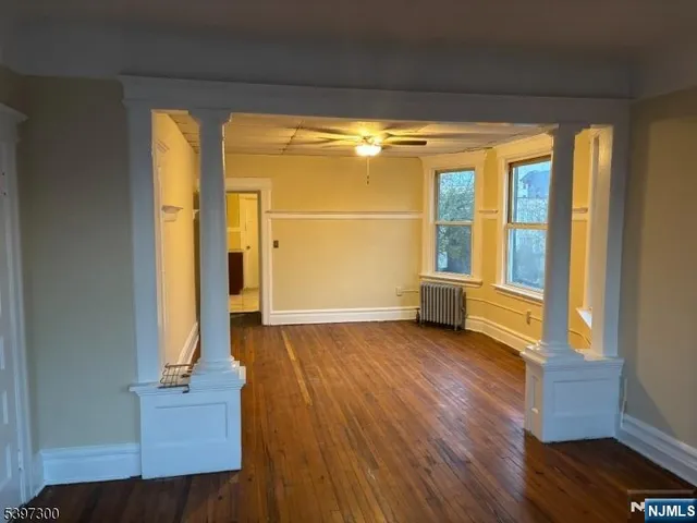 a view of front door with wooden floor and a window
