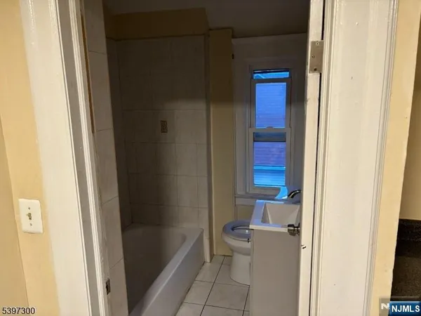 a bathroom with a bathtub and a toilet