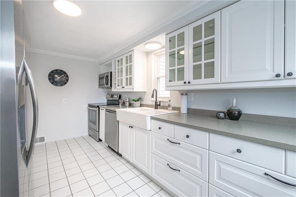 4 Robinhood Road Pittsburgh, PA 15220 - Photo 14 of 25 a kitchen with granite countertop white cabinets and window