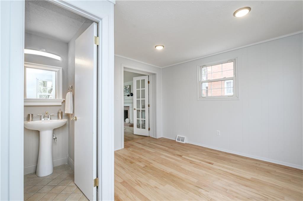 4 Robinhood Road Pittsburgh, PA 15220 - Photo 7 of 25 a view of a hallway with wooden floor and a kitchen