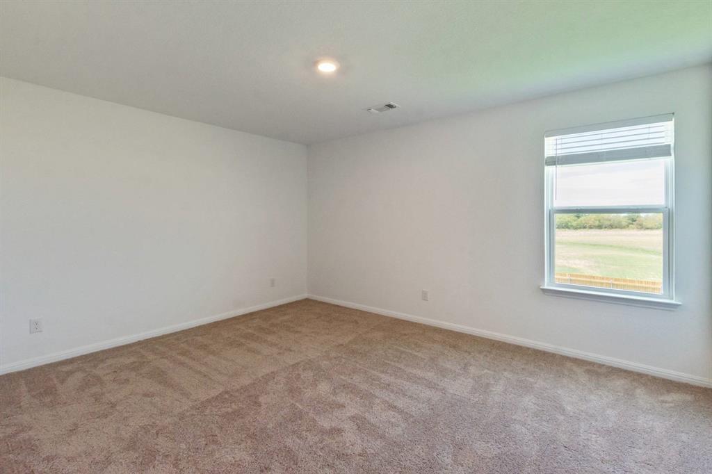 16429 Farmhouse Lane Elgin, TX 78621 - Photo 17 of 22 Neutral-toned carpeting paired with white walls, a single window featuring blinds, and an overhead recessed light fixture