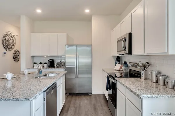 a kitchen with a sink a counter and chairs