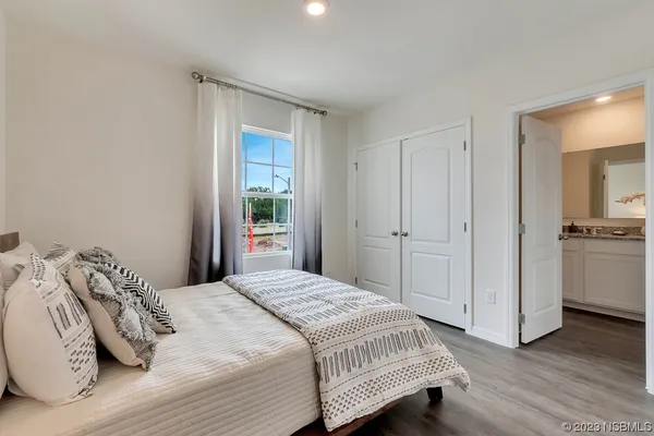 a bedroom with a bed and a night stand