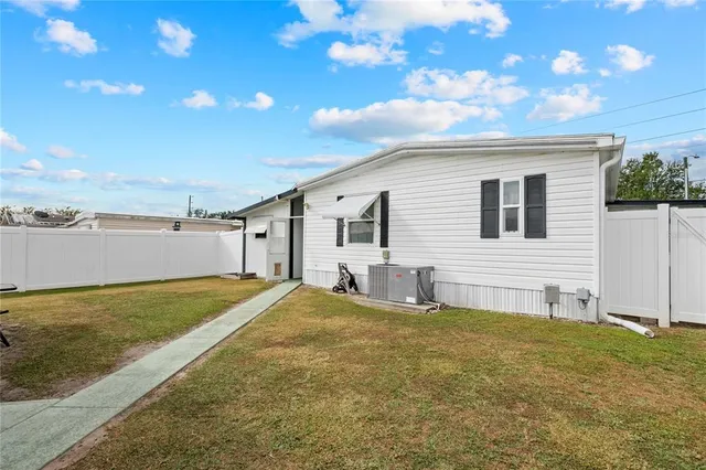a backyard of a house with lots of green space and fountain