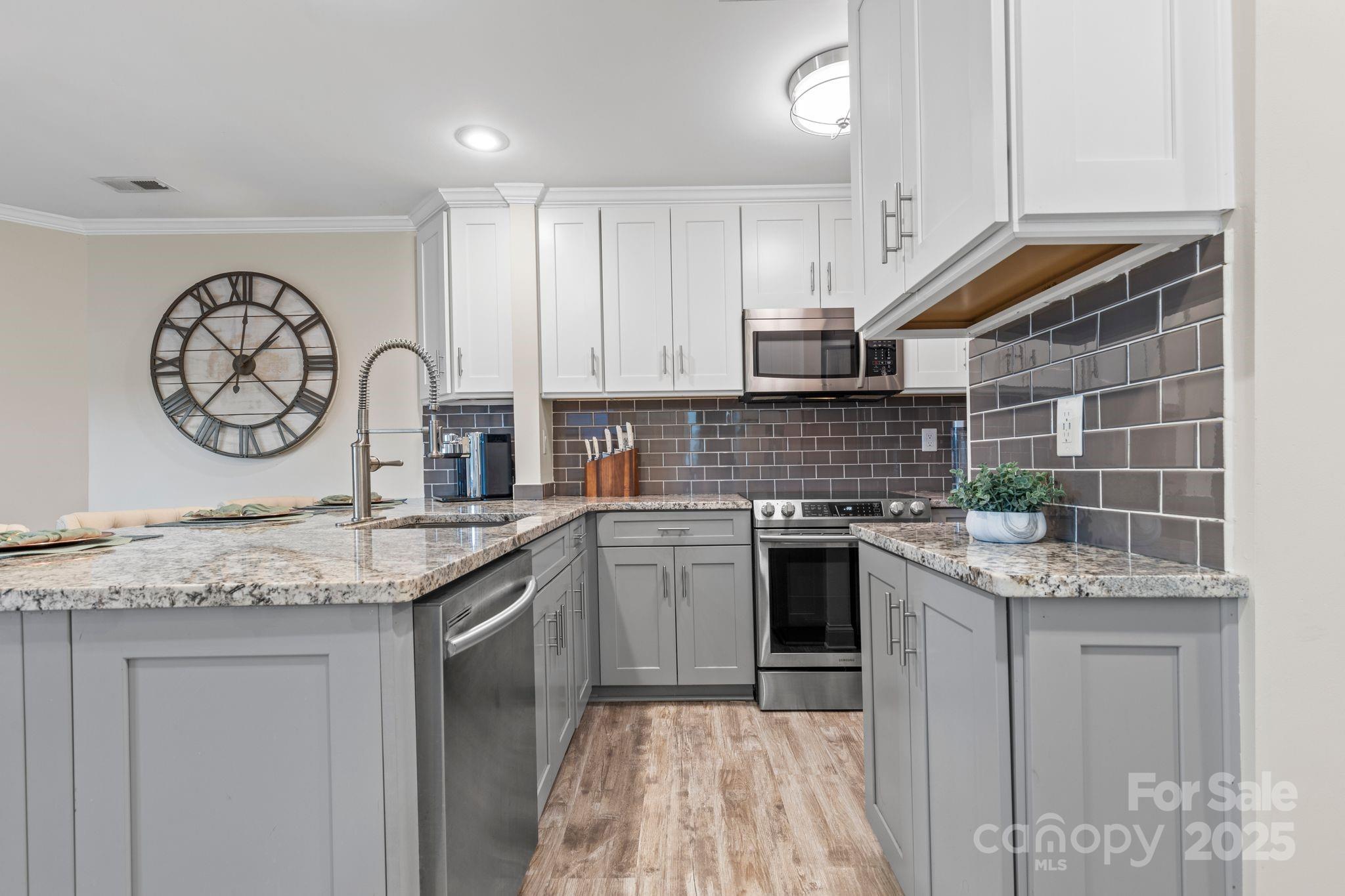 2121 Regatta Lane, Unit 209 Denver, NC 28037 - Photo 14 of 40 a kitchen with stainless steel appliances granite countertop a stove sink and cabinets