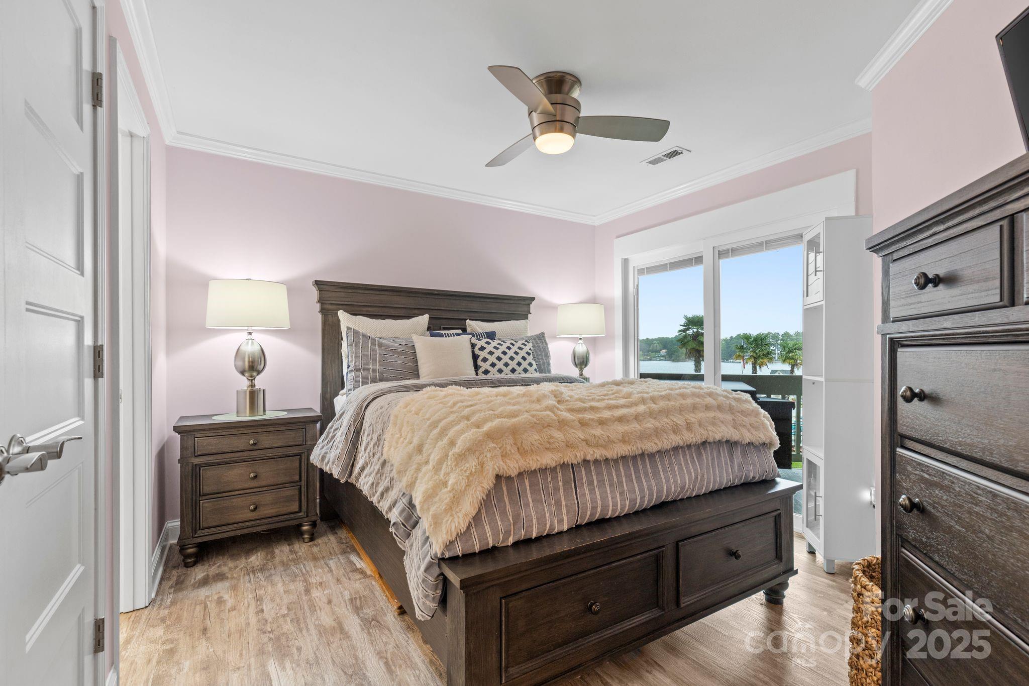 2121 Regatta Lane, Unit 209 Denver, NC 28037 - Photo 16 of 40 a bedroom with a bed and a ceiling fan