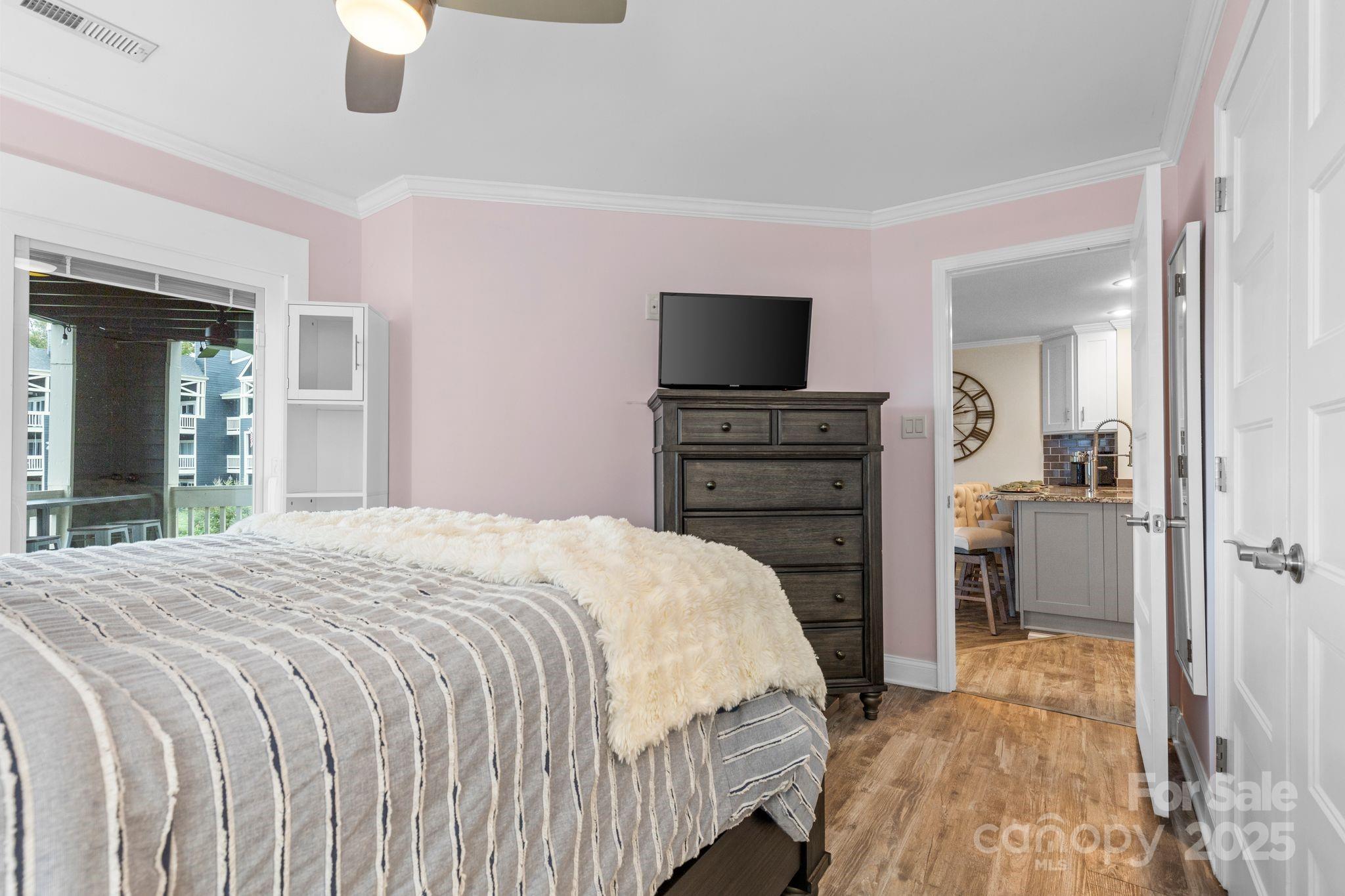 2121 Regatta Lane, Unit 209 Denver, NC 28037 - Photo 17 of 40 a bedroom with a bed and a flat screen tv