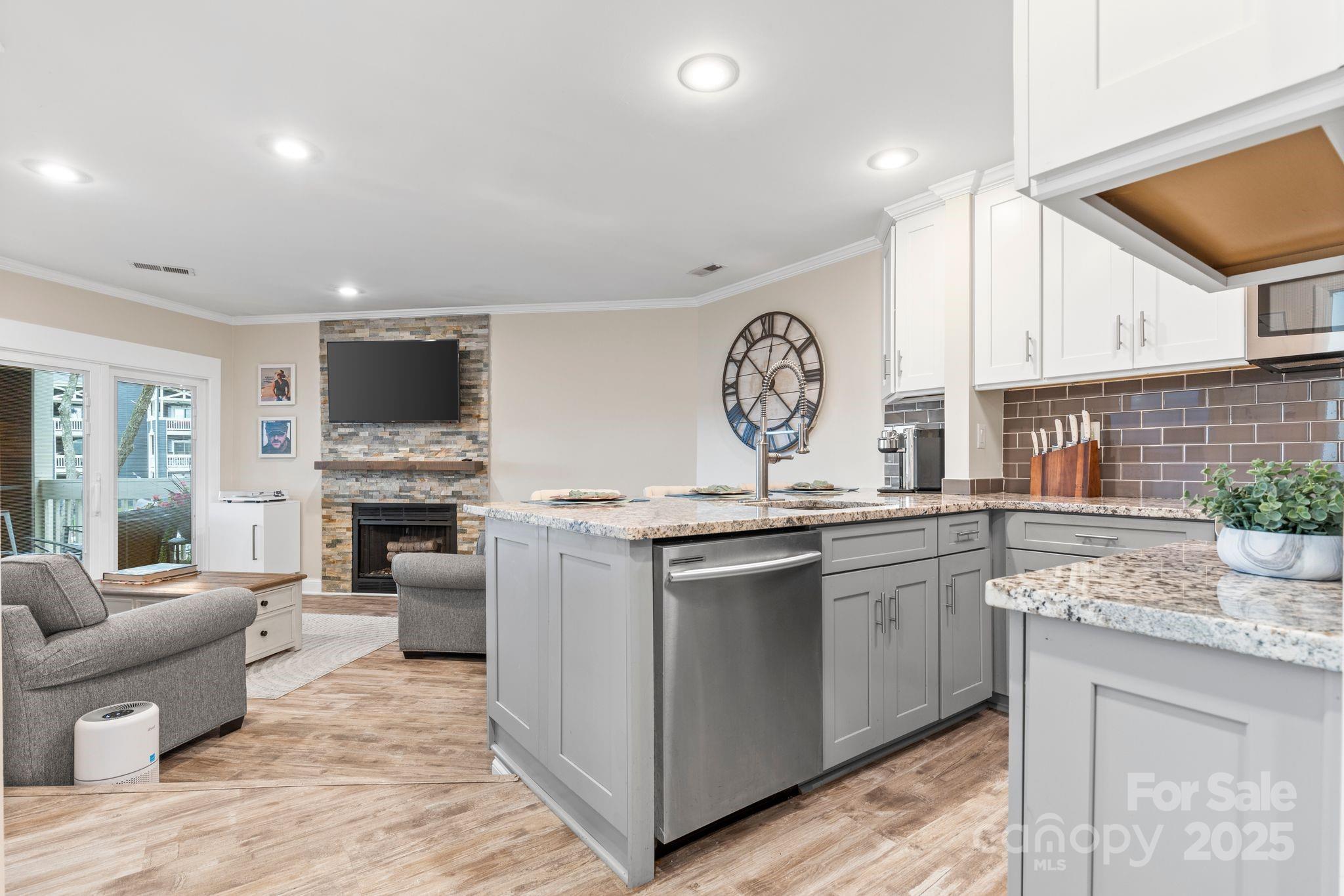 2121 Regatta Lane, Unit 209 Denver, NC 28037 - Photo 6 of 40 a kitchen with granite countertop a stove top oven sink and cabinets