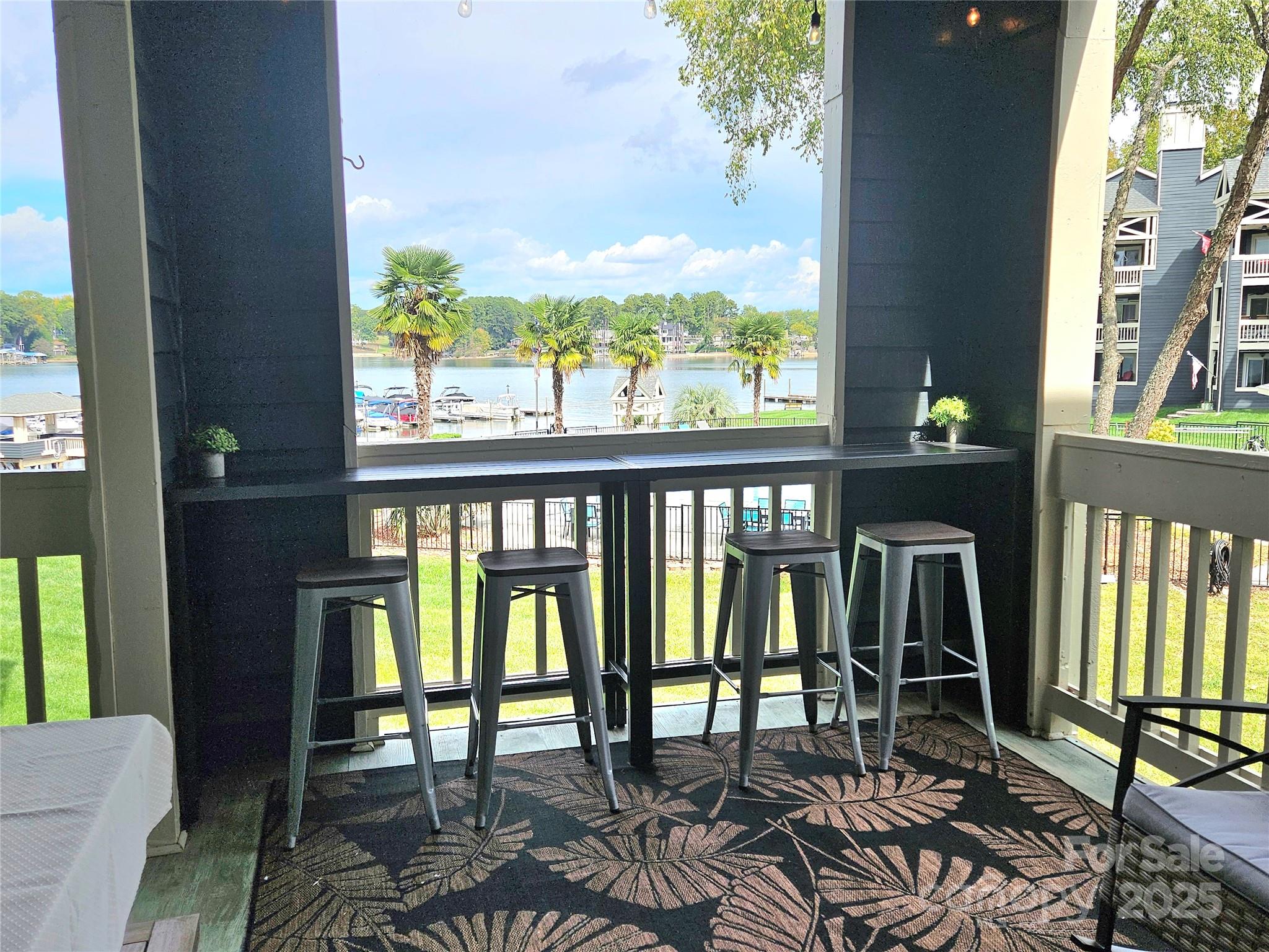 2121 Regatta Lane, Unit 209 Denver, NC 28037 - Photo 9 of 40 a view of a chairs and table in patio with a balcony