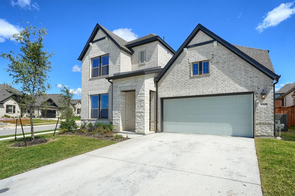 1348 Bay Laurel Road Fate, TX 75087 - Photo 3 of 35 a front view of a house with a garden