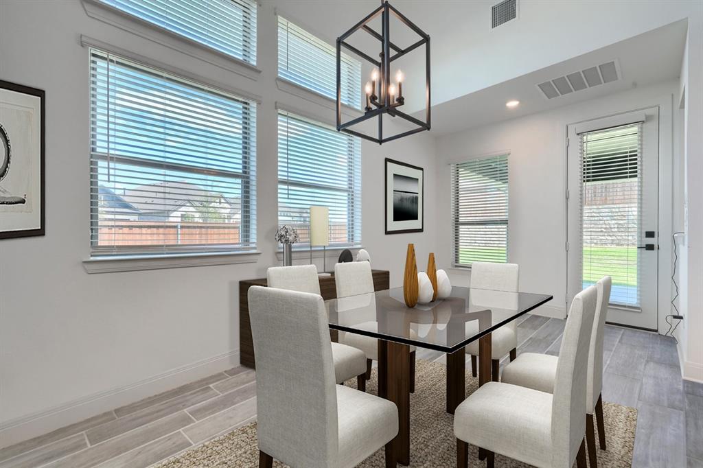 1348 Bay Laurel Road Fate, TX 75087 - Photo 6 of 35 a dining room with furniture a chandelier and wooden floor