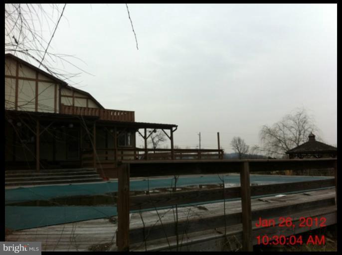 17 Darbys Court Falling Waters, WV 25419 - Photo 6 of 14 a view of a balcony with wooden floor and fence