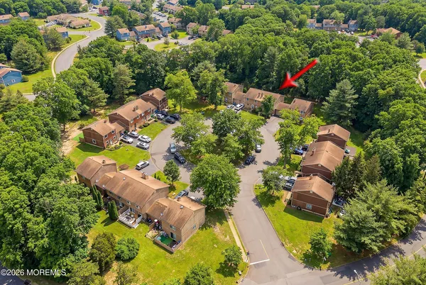 an aerial view of a house with a yard and swimming pool