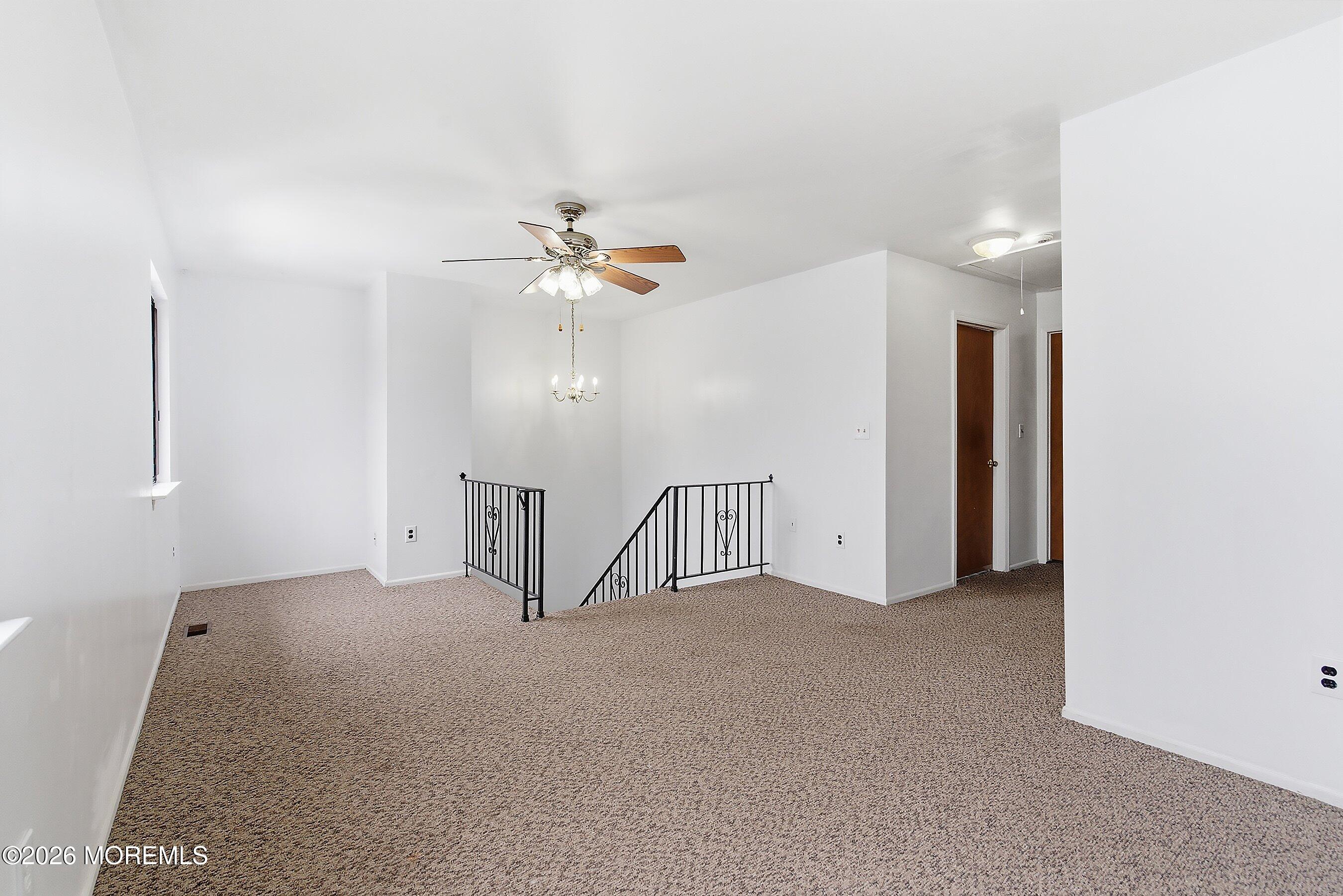 11 Owl Road Howell, NJ 07731 - Photo 18 of 48 a view of an empty room with a chandelier fan
