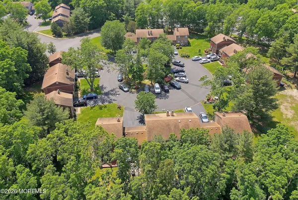 an aerial view of a house with a yard and lake view