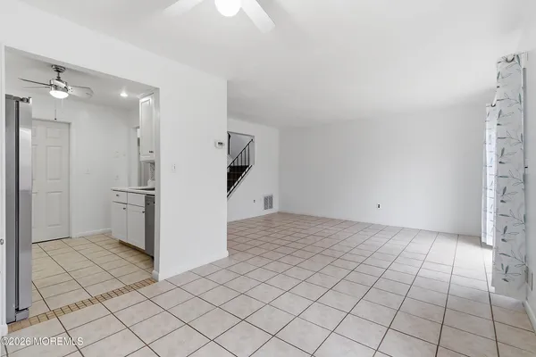 a view of a refrigerator and window in a room