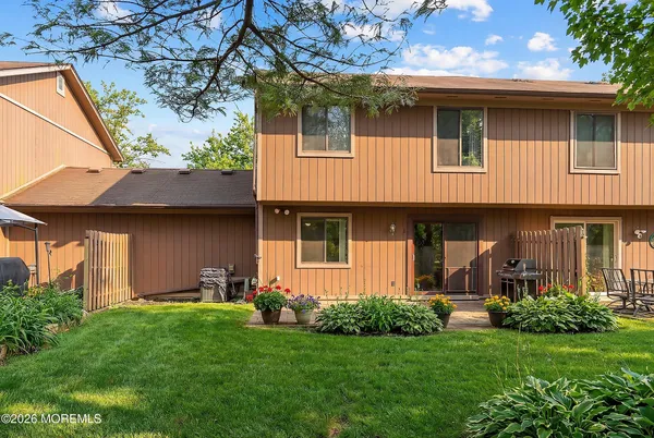 a front view of a house with a garden and plants