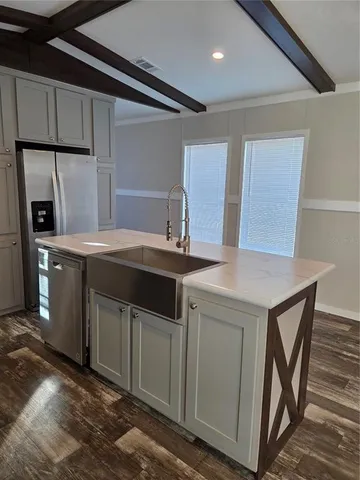 a kitchen with stainless steel appliances a sink stove and refrigerator