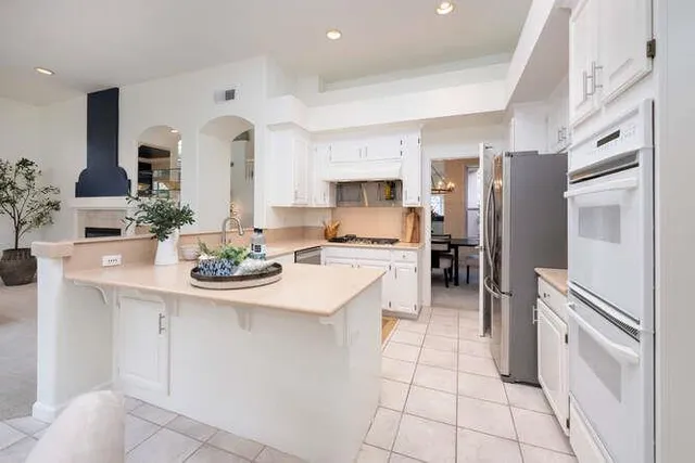 a kitchen with stainless steel appliances a sink stove and refrigerator