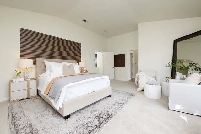 a large bathroom with a tub a sink and a large mirror