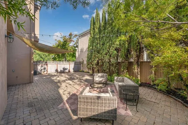 a backyard of a house with outdoor seating