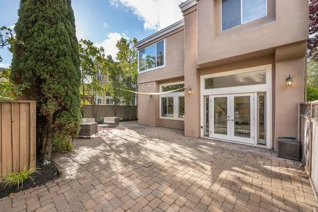a backyard of a house with table and chairs