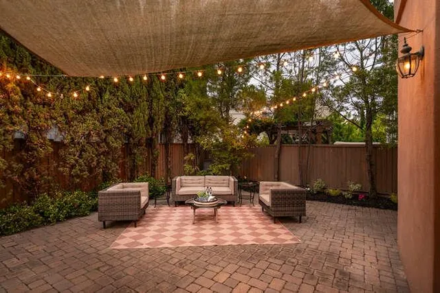 a backyard of a house with fire pit and furniture