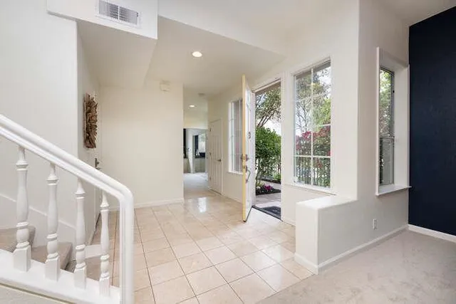 a view of an entryway with wooden floor and a living room