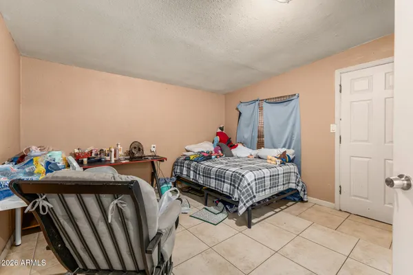 a bedroom with a bed and a table in it